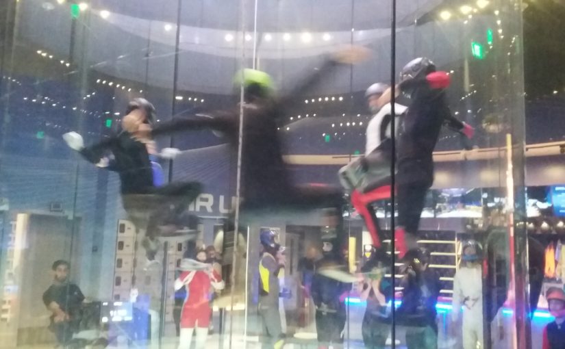 people indoor skydiving